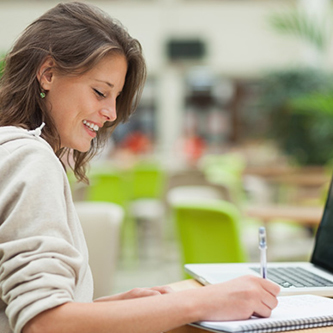 lady writing on a pad of paper