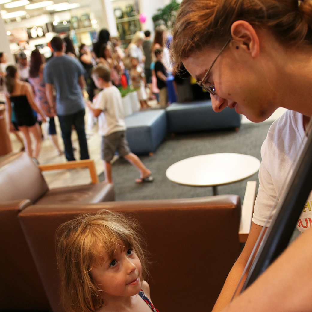 Little girl looking up at her mom