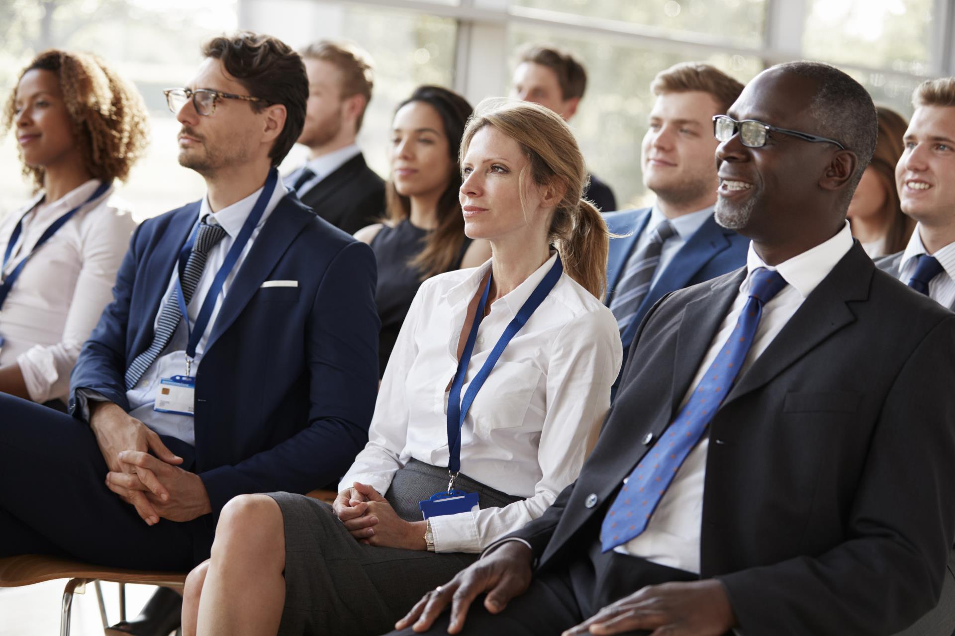 Group of people at a conference seated.