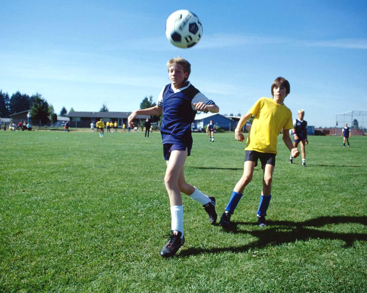 Kids playing soccer.