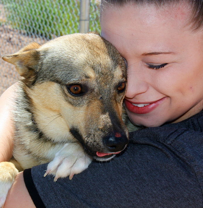 A woman hugging a dog