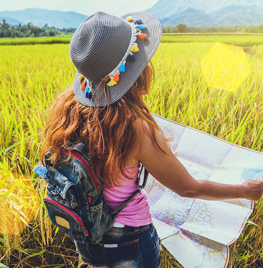 Woman in a field looking at a site plan