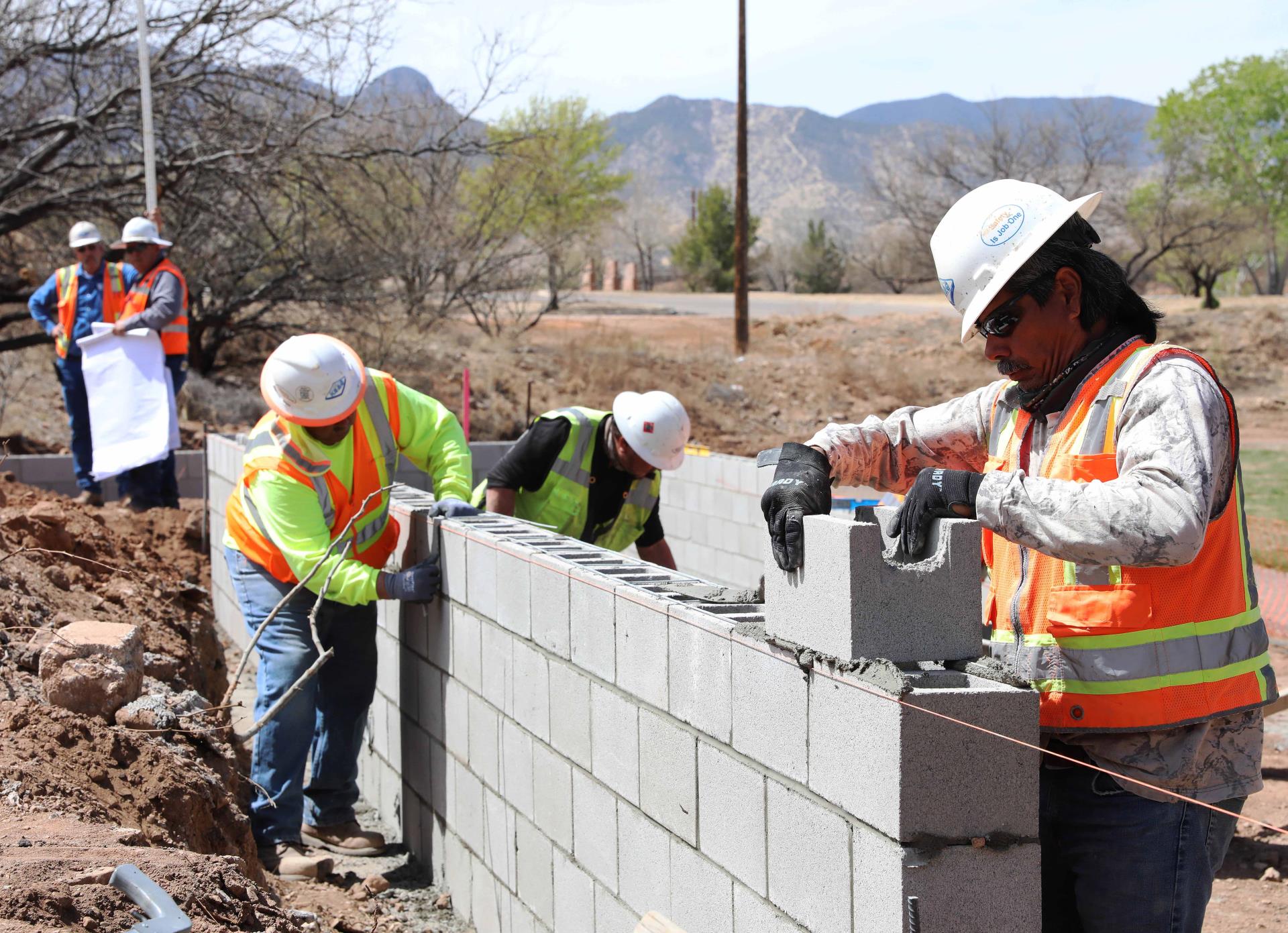 Construction workers laying cinder blocks