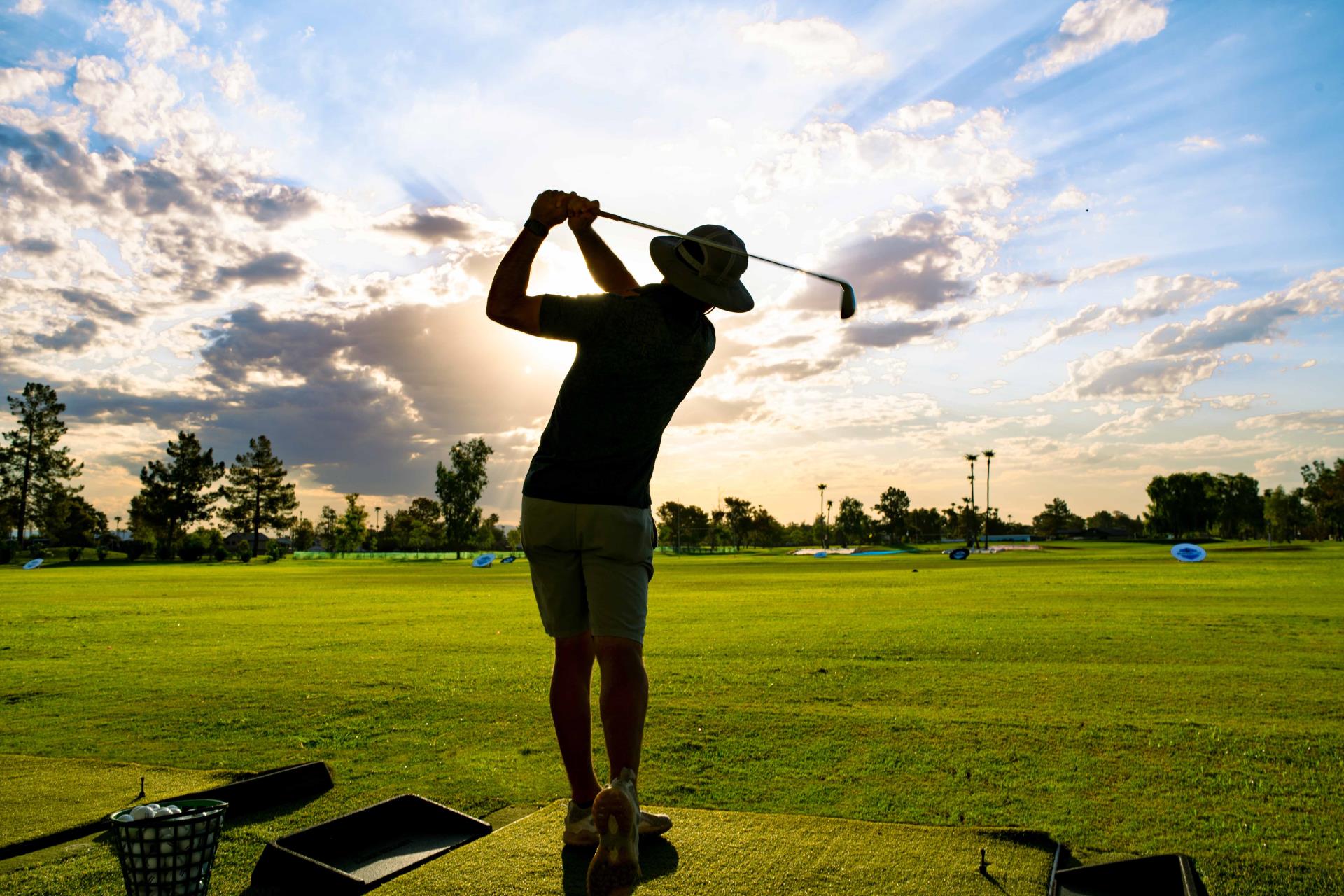 Man hitting ball at driving range