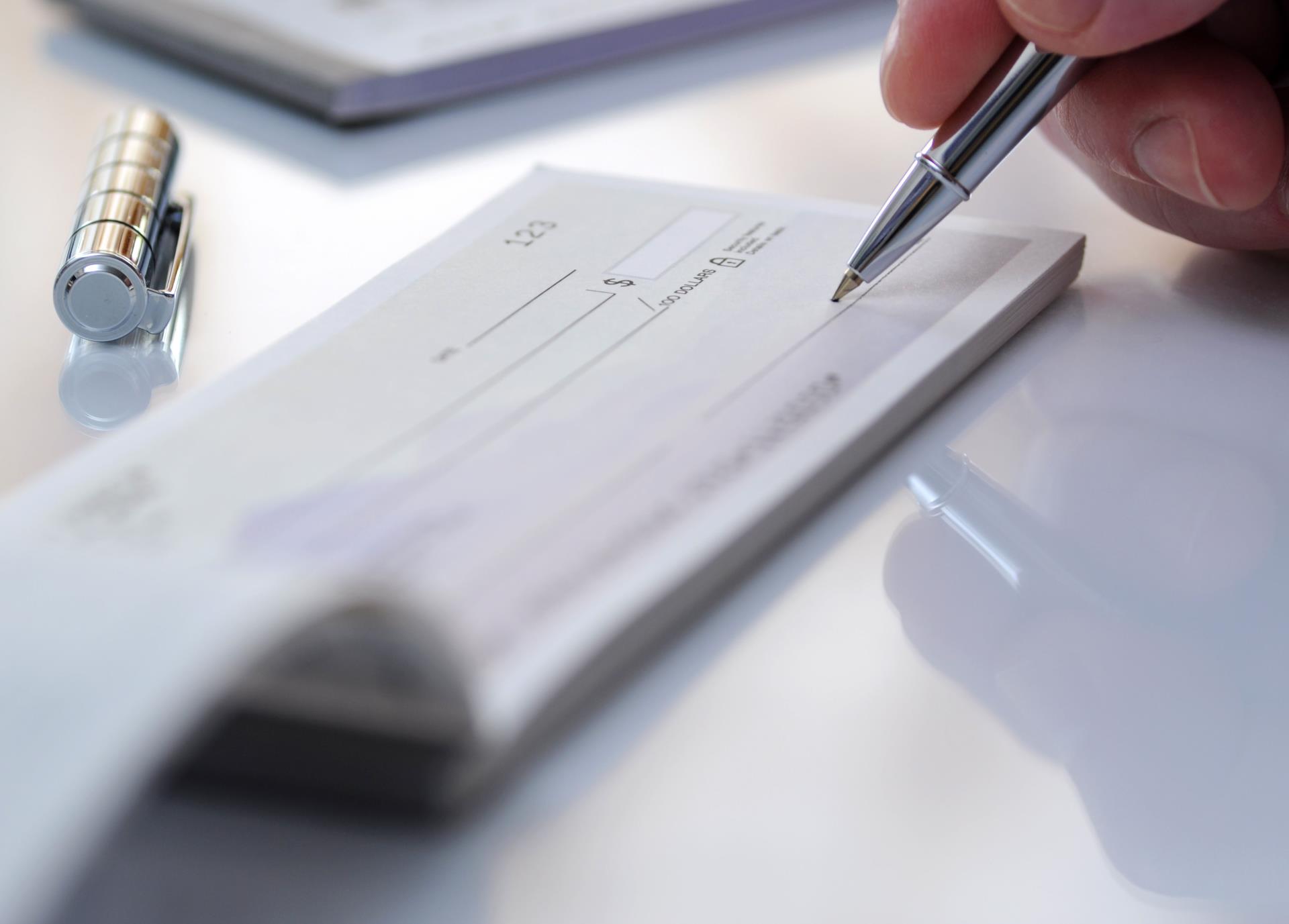 A person signing a check