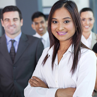 Men and women in business attire smiling