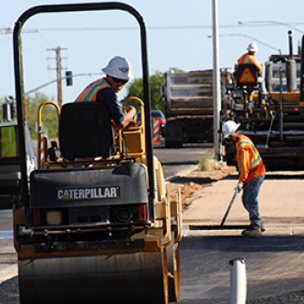 Road workers laying new asphalt on the road