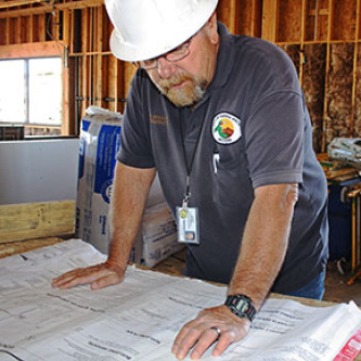 Building inspector examining plans