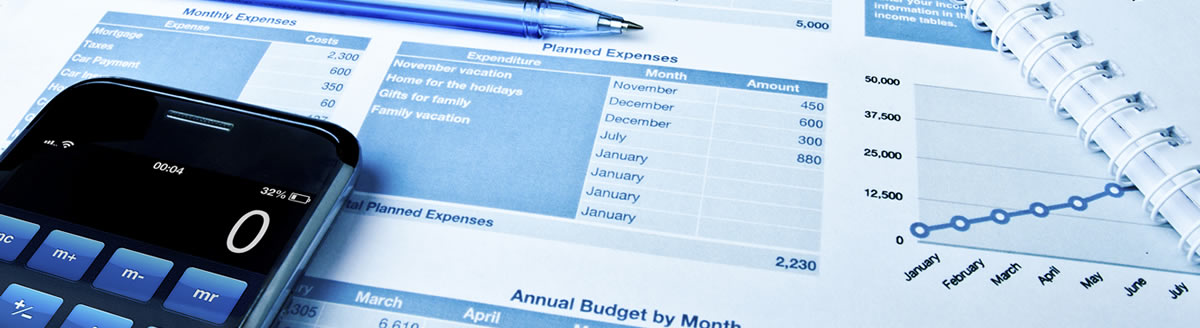 A calculator and an ink pen resting on an expense printout