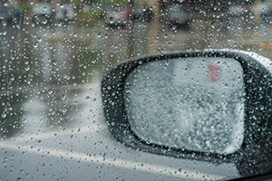 Rain on car window and mirror