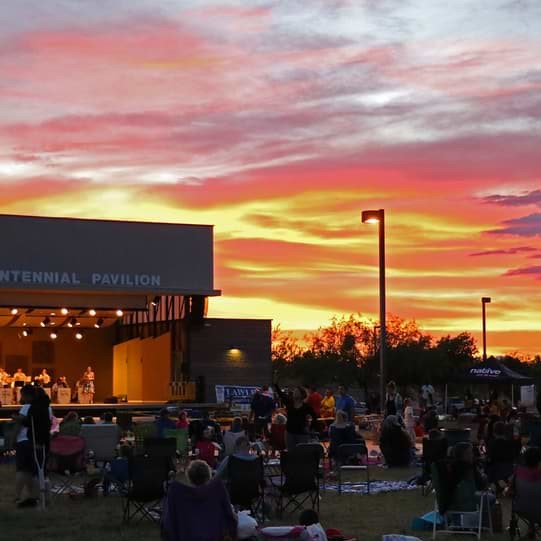 Crowd of people listening to a band at the Centennial Pavilion