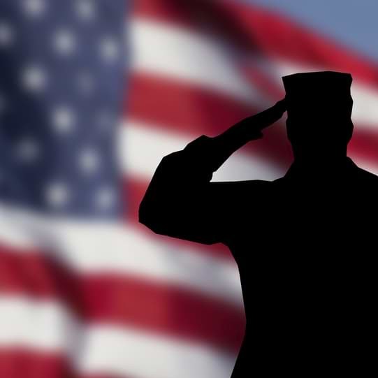 Silhouette of a soldier saluting the American flag