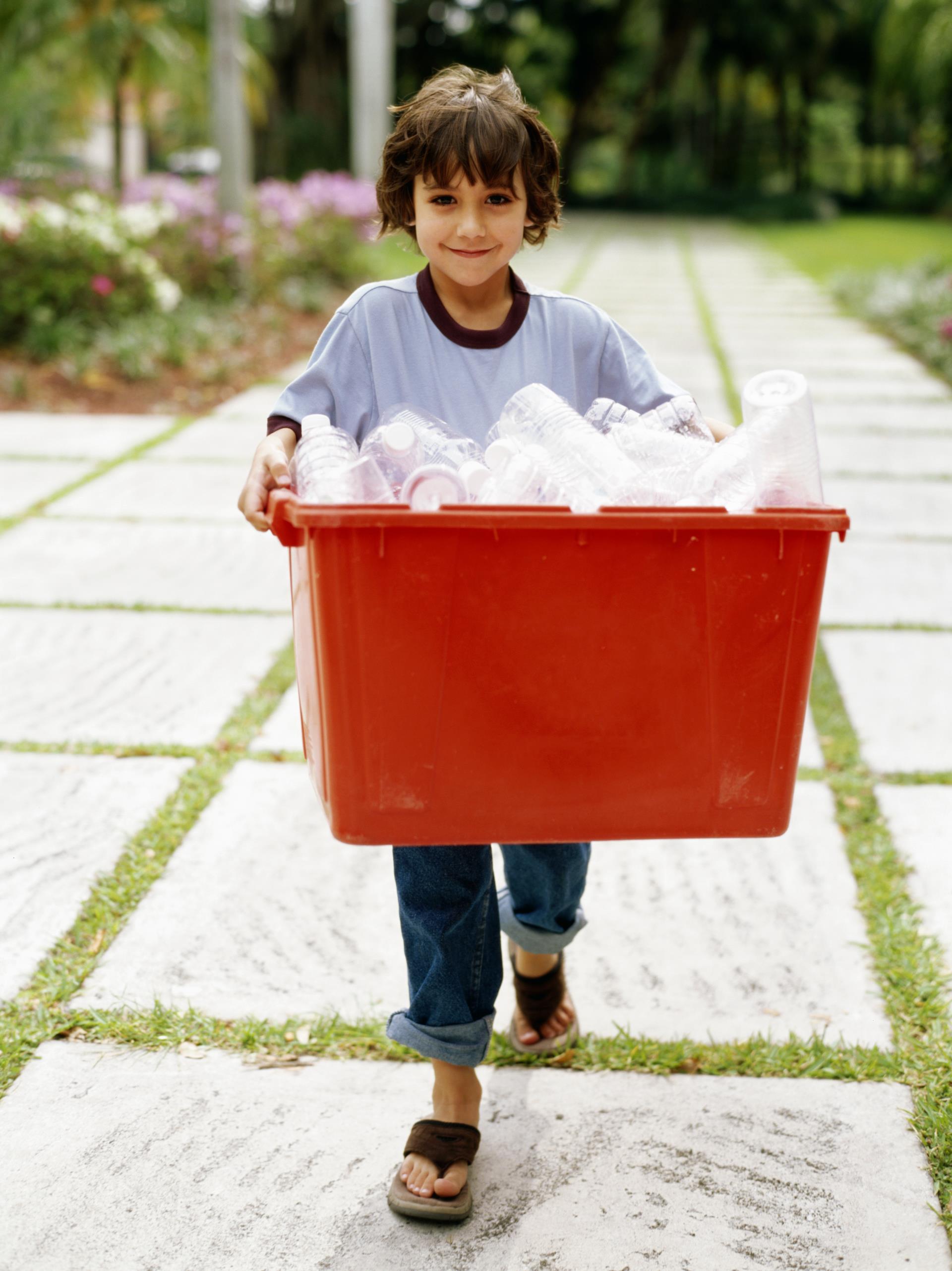 Boy Carrying Red Bin of Plastic Bottles